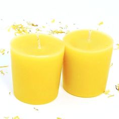 two yellow candles sitting next to each other