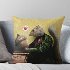 a squirrel sitting on top of a table next to a pillow