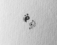 the yin symbol is drawn on top of a piece of white paper with black ink