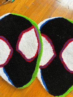 two black and white rugs sitting on top of a wooden floor