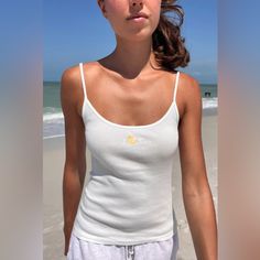 Basic, Cotton, Tank Top With A Scoop Neck And Scalloped Trim With The Yellow Duck Graphic Embroidered On The Chest. Fabrics: 100% Cotton Measurements: 19" (49 Cm) Length, 12" (31 Cm) Bust Made In: Italy White Scoop Neck Top For Beach, Casual Fitted Tops For Beach, Cotton Scoop Neck Beach Top, Cotton Scoop Neck Top For Beach, Fitted Scoop Neck Top For Vacation, Fitted Scoop Neck Top For Beach, Fitted Tops For Summer Loungewear, Fitted Scoop Neck Summer Tops, White Scoop Neck Top For Day Out