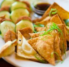 some food is on a white plate with sauce and garnishes around it