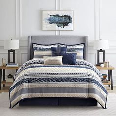 an image of a bed with blue and white comforter