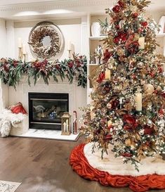 a decorated christmas tree in the corner of a living room with red and gold decorations