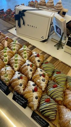 many different types of pastries on display in a store