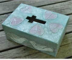 a small box with hearts painted on it