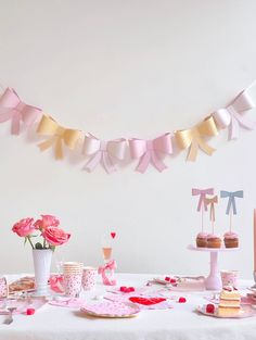 a table with pink and gold decorations on it