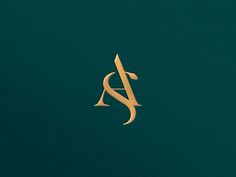 the letter a is made up of gold foil on a dark green background, and it appears to be in cursive font