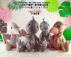 three stuffed animals sitting next to each other in front of a backdrop with palm leaves