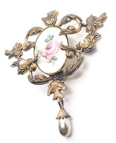 Guillouche pink rose flower white enamel Art Nouveau style faux pearl vintage brooch. Fair vintage condition with small signs of normal vintage wear. Enamel is smooth with no signs of crazing or chips. There is a small amount of discoloration under the seal around the edge as seen in pictures. Small amount of wear on the surface of one pearl accent. Brooch measures 2 and 1/4 of an inch tall and 2 inches wide. White Vintage Brooch Lapel Pin, Vintage Rose Gold Brooches For Wedding, Vintage Rose Gold Wedding Brooches, Vintage Rose Flower Brooch, Vintage Rose Brooch For Gift, Vintage Rose Brooches For Gifts, Vintage Rose Brooches As Gift, Vintage Rose Brooch Jewelry, Vintage Rose Jewelry With Brooch