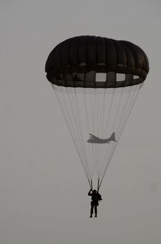 a person is parasailing in the sky with a plane on it's back