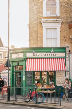 a bike is parked in front of a delicaciesen shop on the street