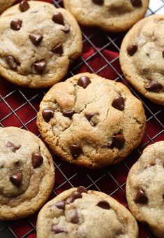 chocolate chip cookies on a cooling rack ready to be eaten by someone in the kitchen