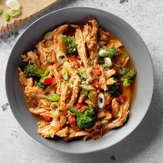 a bowl filled with meat and vegetables on top of a table