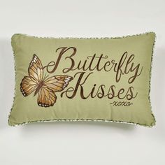 a pillow with a butterfly on it that says, butterfly kissess in cursive writing