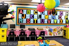 an empty classroom with desks and chairs in front of a large poster on the wall