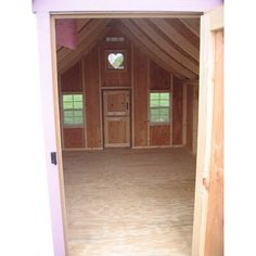 an open door to a room with wooden walls and flooring in the middle of it