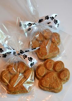 four dog paw shaped cookies wrapped in plastic