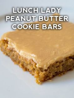 a close up of a piece of cake on a plate with the words lunch lady peanut butter cookie bars