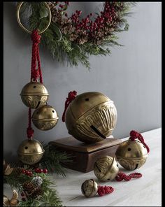 an assortment of bells and ornaments on a table