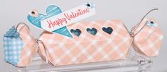 an origami box with hearts on it and a happy valentine tag hanging from the top