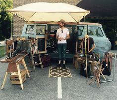 a man standing in front of an old van