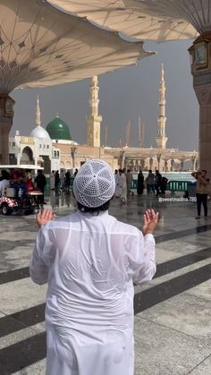 a man standing in the middle of a courtyard