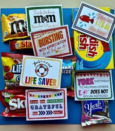 candy wrappers are laid out on top of a blue board with the words, life saver, and other stickers