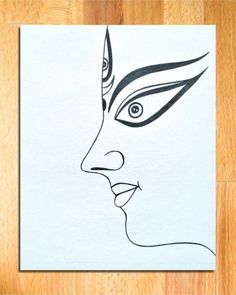 a drawing of a woman's face on paper