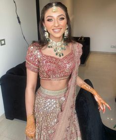 a woman in a bridal outfit posing for the camera