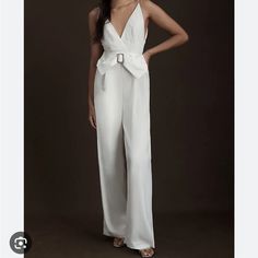 With A Detachable Belt Featuring A Large Satin Bow And Crystal-Embellished Buckle, The Nole Jumpsuit Also Boasts A Deep-V Front And Back, Ensuring A Standout Silhouette That's Sure To Turn Heads. Nylon Back Zipper Detachable Belt Deep-V Front And Back Dry Clean Imported Dimensions Falls 61.5" From Shoulder 13.5" Rise 33.5" Inseam Simple White Jumpsuit, Anthropologie Bridal, Bridal Pantsuit, Bride Jumpsuit, Nontraditional Wedding Dress, Stylish Wedding Dresses, Satin Jumpsuit, Bridal Jumpsuit, Wedding Jumpsuit