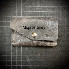 This perfectly sized small unisex American bison leather double pocket snap wallet is great for those wanting to reduce the bulk of their wallet, or who would like to leave the larger purse or tote at home. Great for a business cards and easy access. The practical and durable snap keeps all your valuables in place without adding significant bulk. It's designed with two pockets to keep your cards and bills organized in a wonderfully compact wallet. This is an elegant and rustic solution when you Gray Wallets With Card Slots For Everyday Use, Gray Rectangular Wallet For Everyday Use, Gray Leather Wallet For Everyday Use, Gray Leather Wallet, Bill Organization, Bison Leather, Snap Wallet, American Bison, Steamboat Springs