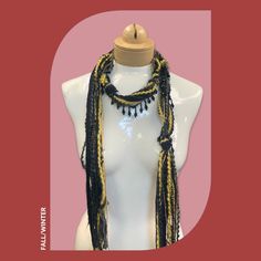 Discover this stunning bohemian beaded scarf necklace, crafted from luxurious Italian mohair yarn. The perfect lightweight accessory to elevate your holiday style. Features: Black and gold color combination Mohair yarn Italian craftsmanship Lightweight and comfortable Beaded details Linen gift pouch Benefits: Adds a touch of bohemian elegance to any outfit Perfect for the holiday season Luxurious and high-quality materials Versatile and can be worn in multiple ways Makes a thoughtful and stylish Elegant Gold Scarf One Size, Bohemian Black Handwoven Beaded Necklaces, Black Bohemian Beaded Necklace For Festive Occasions, Bohemian Black Hand Knotted Jewelry, Handmade Elegant Scarves One Size, Bohemian Black Handmade Scarves, Bohemian Black Handmade Scarf, Handmade Yarn Bohemian Scarves, Handmade Bohemian Yarn Scarves