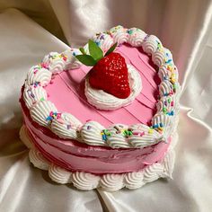 a heart shaped cake with a strawberry on top