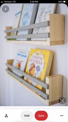 two wooden bookshelves holding children's books on the side of a wall