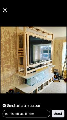 a television is sitting on top of a shelf in a room that has been built into the wall