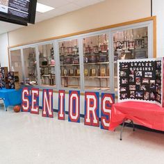 a sign that says seniors on it in front of a display case filled with items