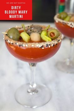 two glasses filled with different types of food on top of a white countertop next to each other