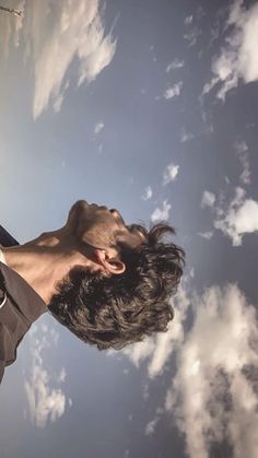 a man flying through the air while holding onto a kite string in front of his face