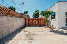 an empty backyard with a wooden fence