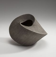 a sculpture made out of wood on a white surface with grey background and black edges