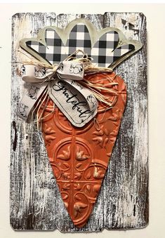 a wooden plaque with a heart shaped decoration on it