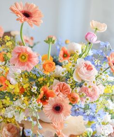 a vase filled with lots of different colored flowers