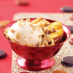 a red bowl filled with ice cream and fruit