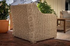 a wicker chair sitting on top of a brick patio