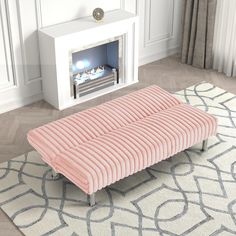 a pink bench sitting on top of a rug next to a fire place in a living room