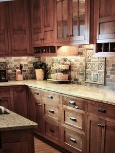 a kitchen with wooden cabinets and tile backsplashes on the counter top, along with a sink