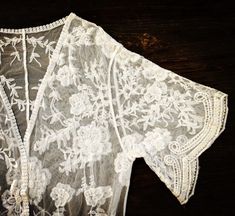 "This overlayering piece is made with soft embroidered sheer lace, features mid sleeve with scalloped sleeve edge and hem. Makes for a super sweet cover up for any outfit! ONE SIZE FITS MOST - SMALL, MEDIUM, LARGE Length: 37\" Bust: 23\" (open front, one size fits all) Armhole: 11\" Now when you order two items or more, your shipping is on us! Enter FREESHIP at checkout! ( US shipping only) And/Or Share your photo with me in the item you purchased, you will receive a $15 coupon toward your next Bohemian Lace Patchwork For Spring, Bohemian Fitted Lace For Spring, Fitted Bohemian Lace For Spring, Bohemian Open Front Kimono With Floral Embroidery, Bohemian Floral Embroidered Open Front Kimono, Bohemian Summer Lace With Lace Patchwork, Bohemian Lace With Lace Patchwork For Summer, Fitted Summer Kimono With Embroidery, Fitted Summer Embroidered Kimono