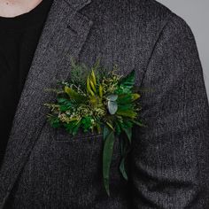 a man in a suit with a boutonniere on his lapel flower