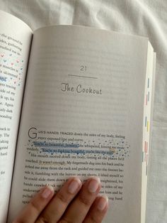 a person holding an open book in their hand